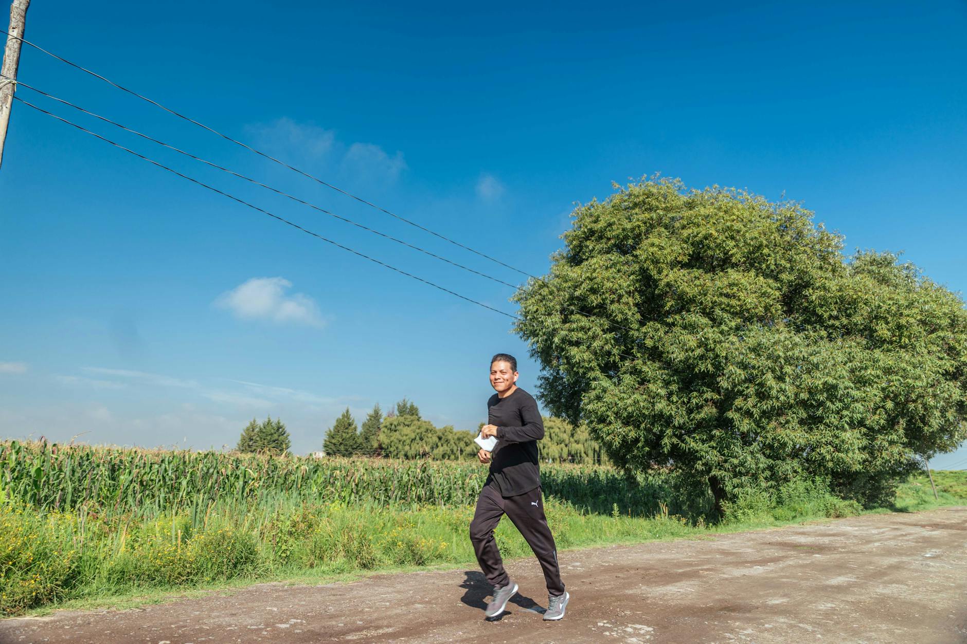 https://www.pexels.com/photo/man-running-on-dirt-road-near-field-17979526/